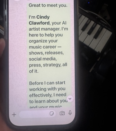 Cindy Clawford introducing herself on WhatsApp: I'm your AI artist manager, here to help organize your music career — shows, releases, social media, press, strategy.